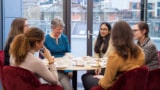 Students enjoying a tea with Dame Jocelyn Bell Burnell at the Institute of Physics HQ in London