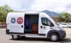 A van used as a mobile testing centre for measuring THC in the breath of cannabis users. The van door is open, revealing a psychedelic purple wall hanging and a chest of drawers inside